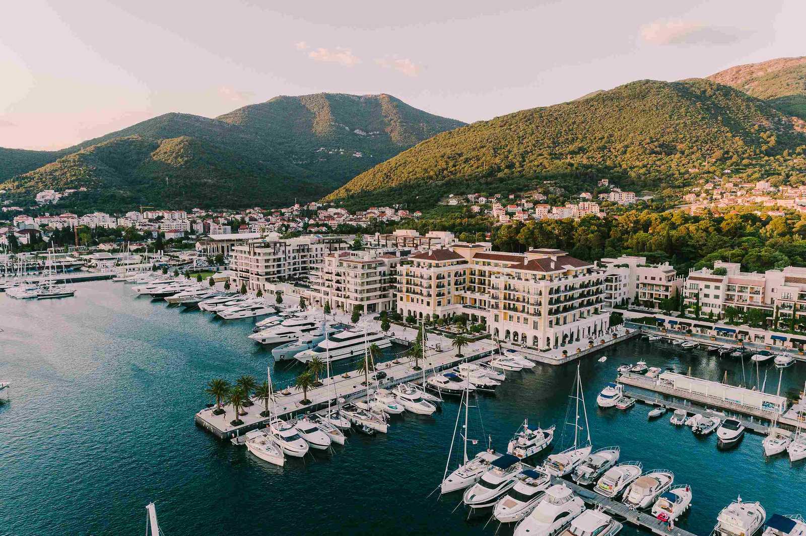 Catamaran in Montenegro's Bay of Kotor beside mountains and coastal towns